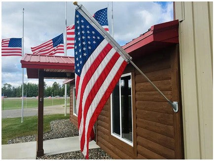 Residential American flag and house-mounted flagpole displayed with mounting accessories