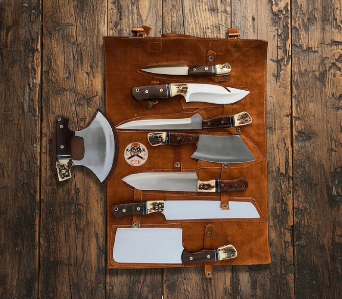 Kitchen knives displayed with a leather roll for protected cutlery storage and transport