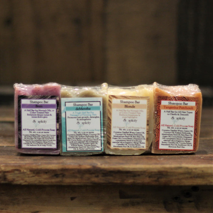 Assorted American-made solid shampoo bars arranged in a shampoo bar sampler set for hair cleansing