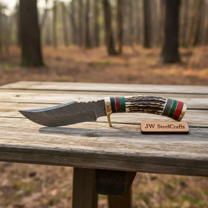 Fixed blade Damascus steel skinner knife with antler handle and leather sheath
