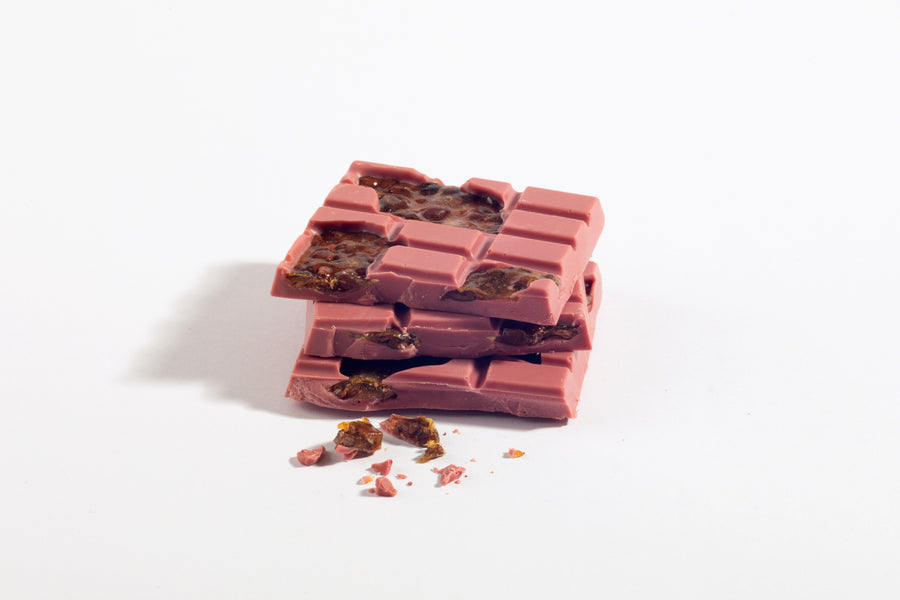 Stacked pieces of Ruby Chocolate Cocoa Nib Brittle Bar