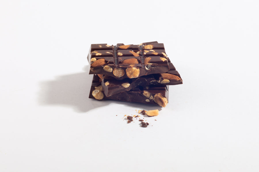 Stacked Tres Cojones mixed-nut dark chocolate bar pieces