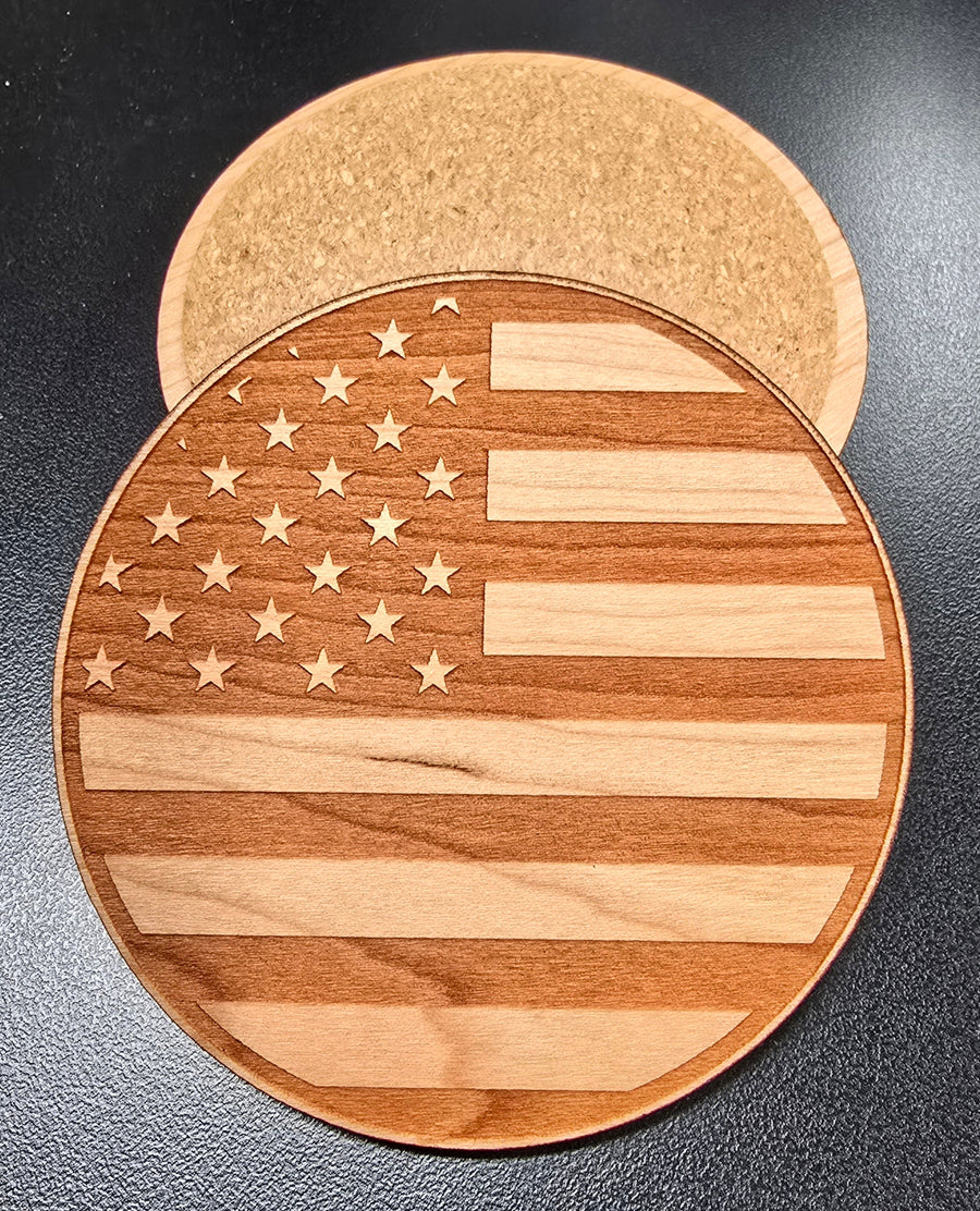 Stack of round American flag wooden coasters showing engraved stars and stripes