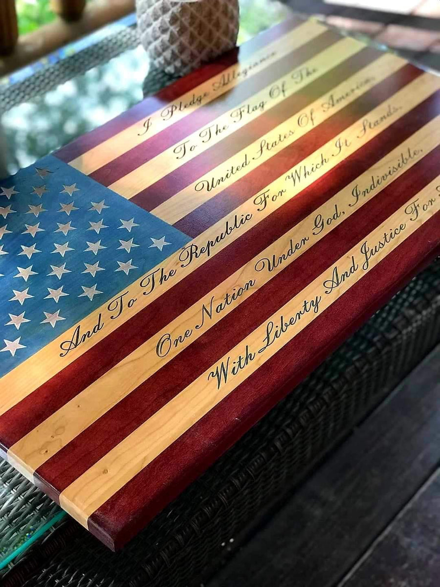 Close-up of pledge lettering and wood grain on a wooden American flag