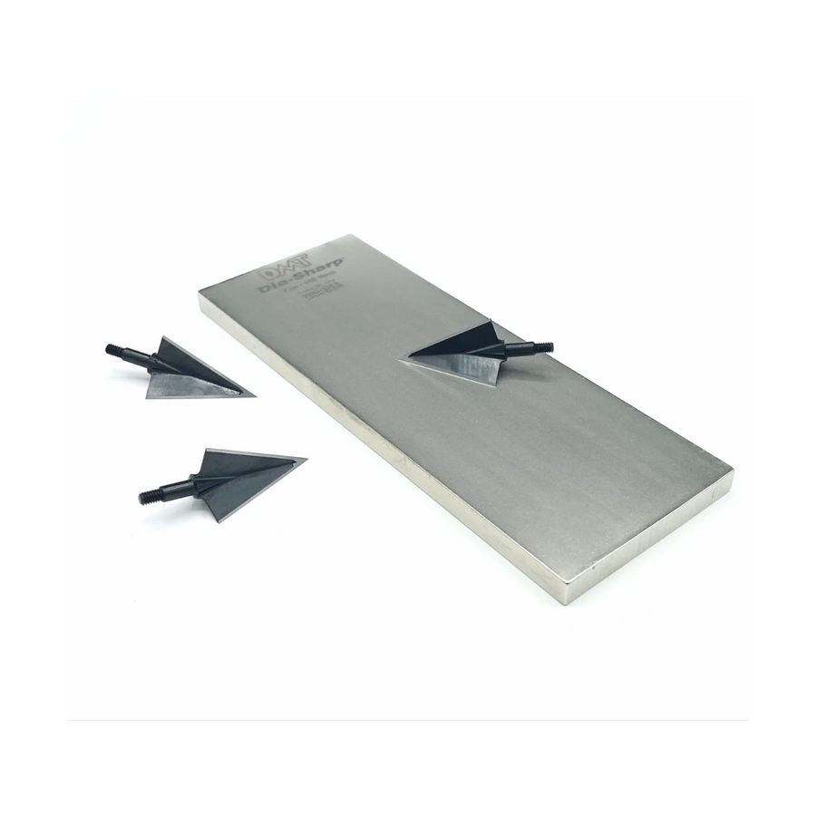 Broadheads displayed on a full-size diamond sharpening stone