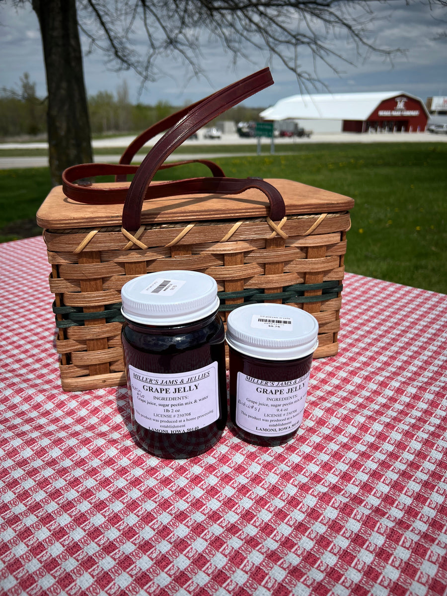 Miller’s Grape Jelly photographed beside a picnic basket outdoors
