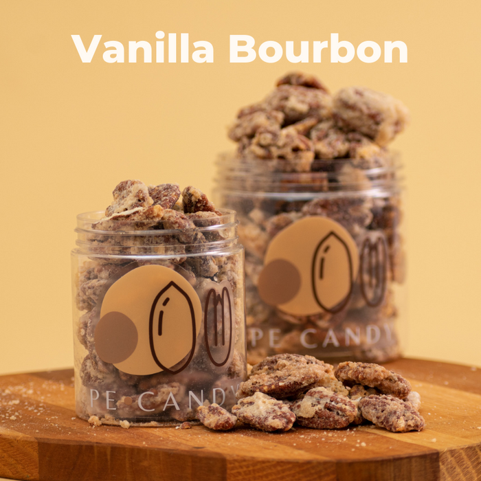 Vanilla Bourbon candied pecans in an open jar with loose pecans on a gold background