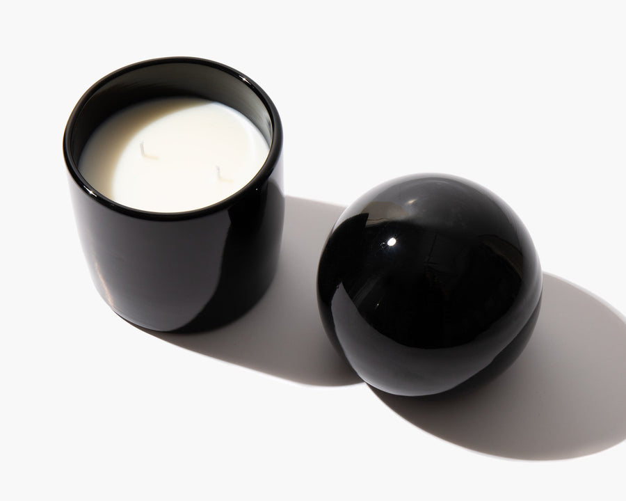 Overhead view of candle wax with the glass orb lid alongside