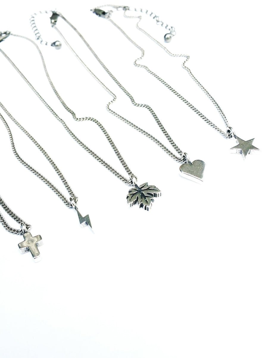 Comparison of small charm necklaces including the Mini Cross
