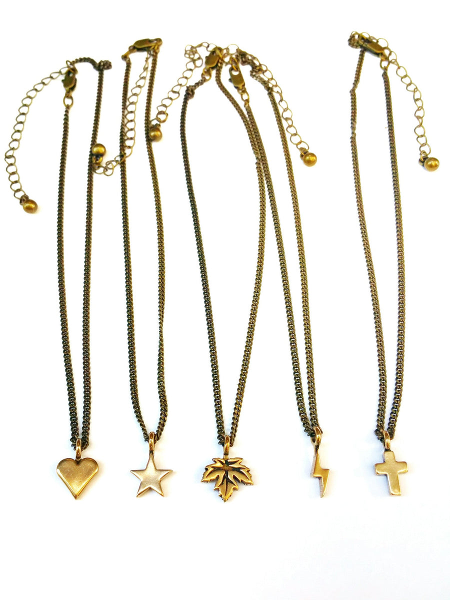 Comparison of small charm necklaces including the Mini Cross
