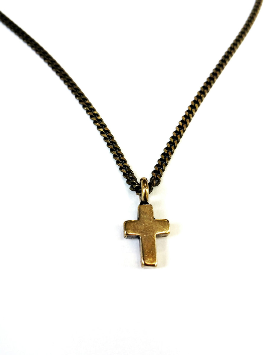 Close view of Mini Cross charm on curb chain