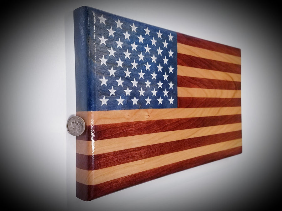 Angled view of Young Glory desktop American flag showing wood grain