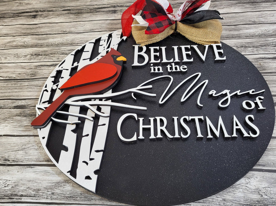 Close-up of the painted cardinal and Believe in the Magic of Christmas greeting