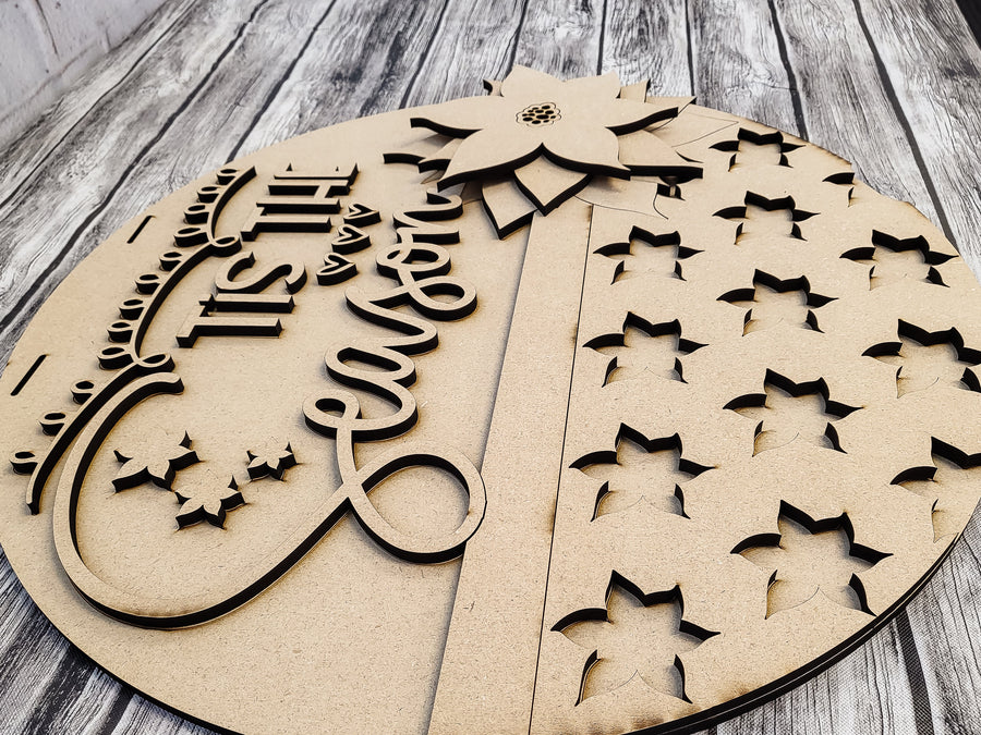 Separate poinsettia and lettering pieces on the unfinished backer