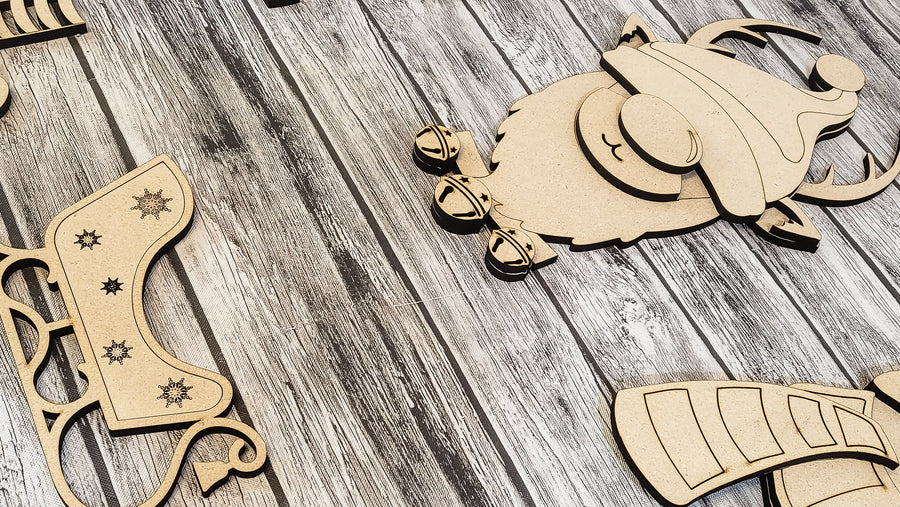 Close-up of cut MDF winter gnome parts on a wood background