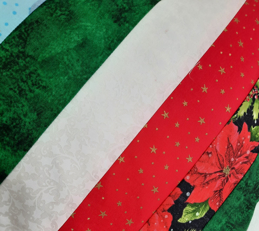 Snowman & Poinsettia Patchwork Pillow Cover, close-up of the fabric design