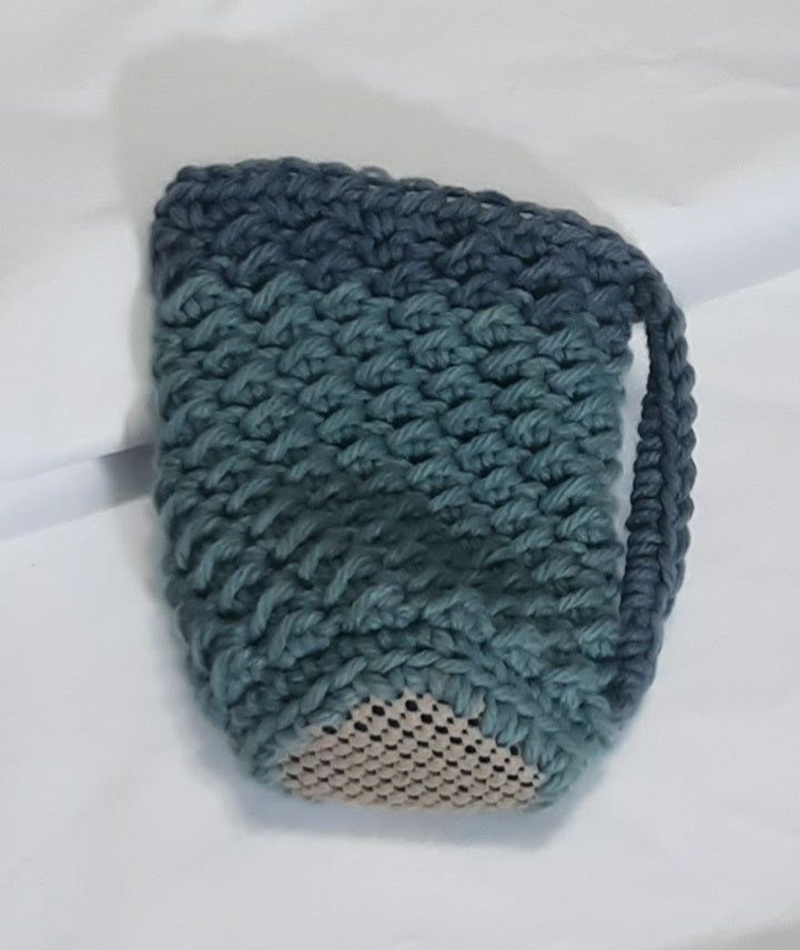 Green Crochet Cup Cozy, angled view showing the underside and base