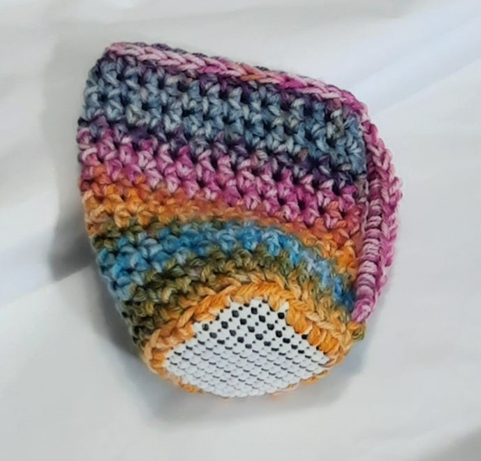 Rainbow Crochet Cup Cozy, angled view showing the underside and base