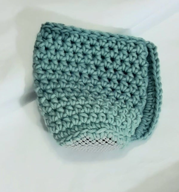 Mint Green Crochet Cup Cozy, angled view showing the underside and base