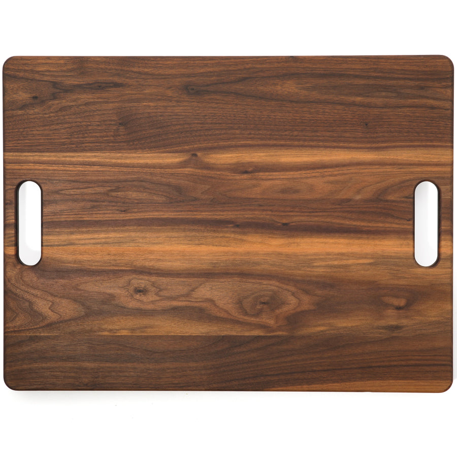 Plain side of a walnut board with two cutout handles