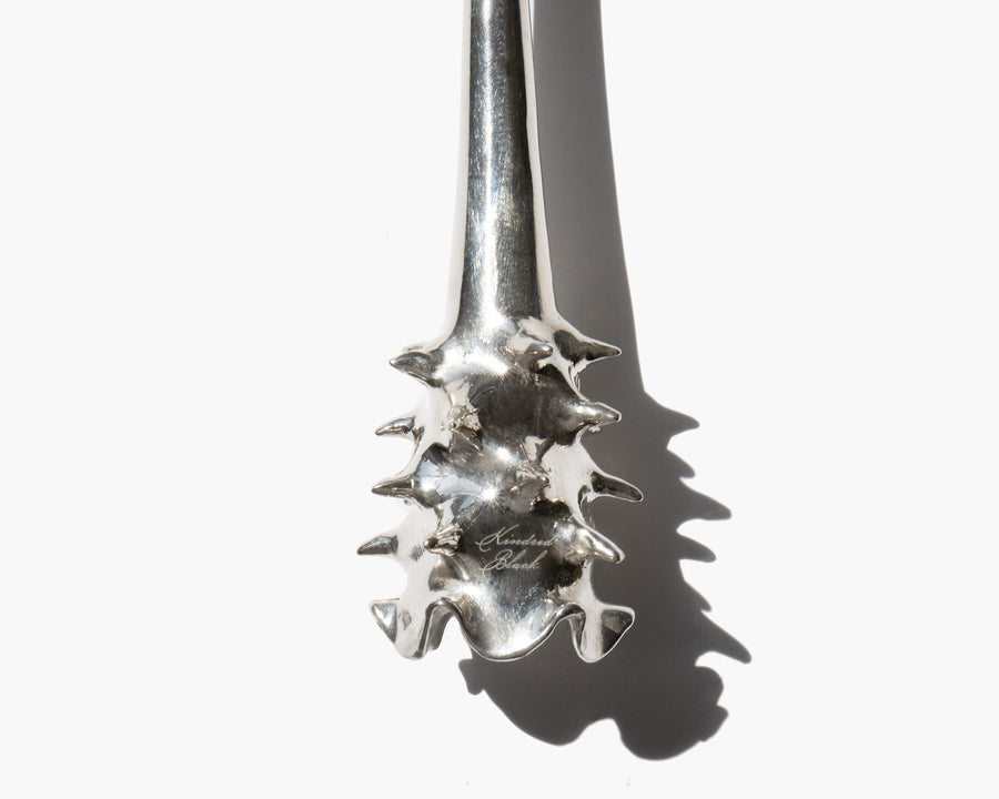 Detailed view of the textured silver snuffer base