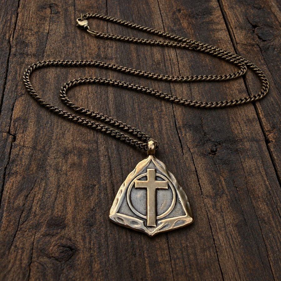 Resurrection Cross necklace arranged on wood