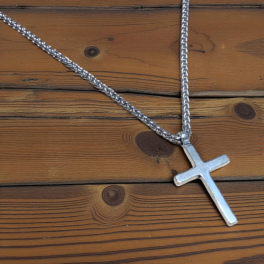 Classic Cross pendant and chain on wooden boards