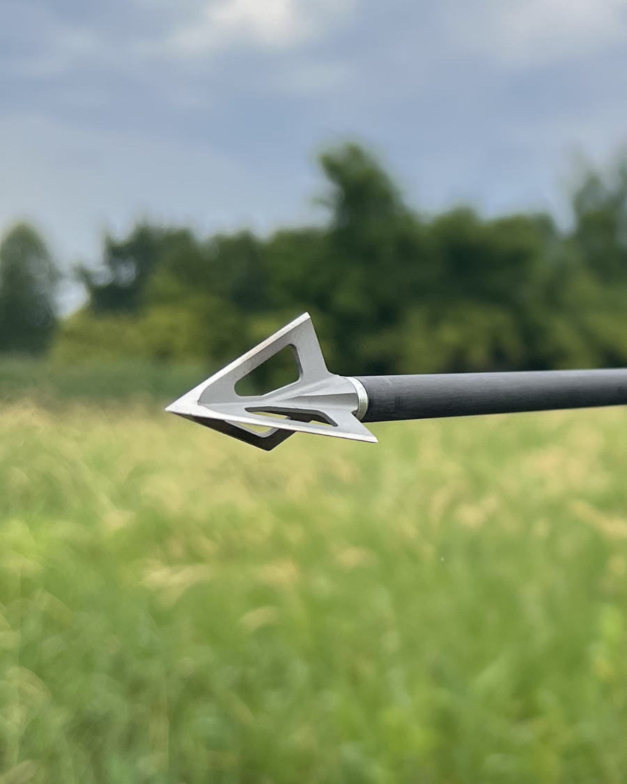 Vented stainless broadhead on an arrow outdoors
