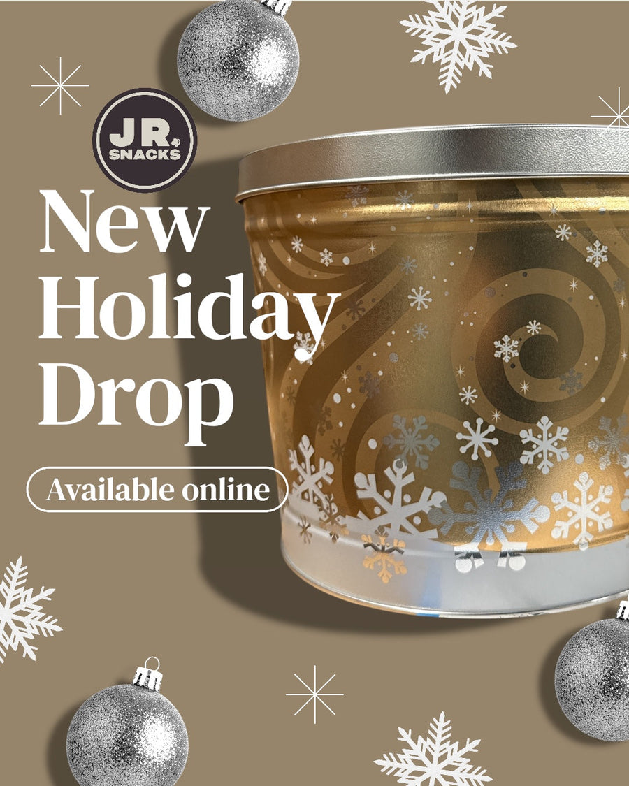 Holiday popcorn tin with a gold seasonal design and New Holiday Drop text