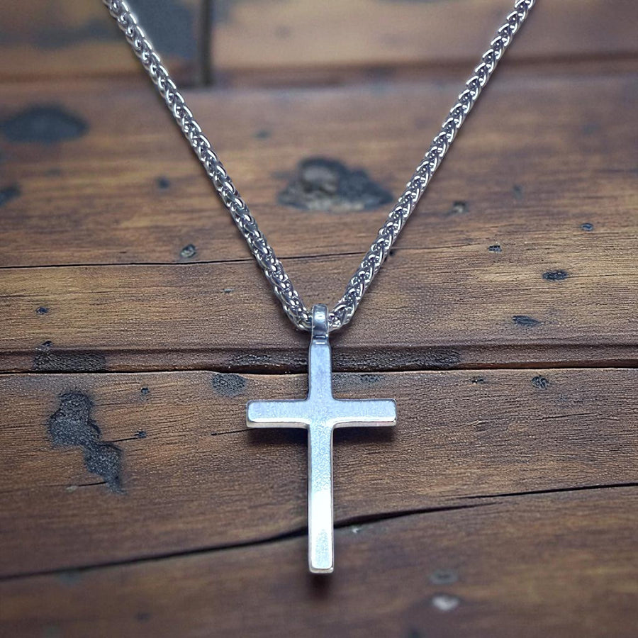Classic Cross necklace on wheat rope chain against wood