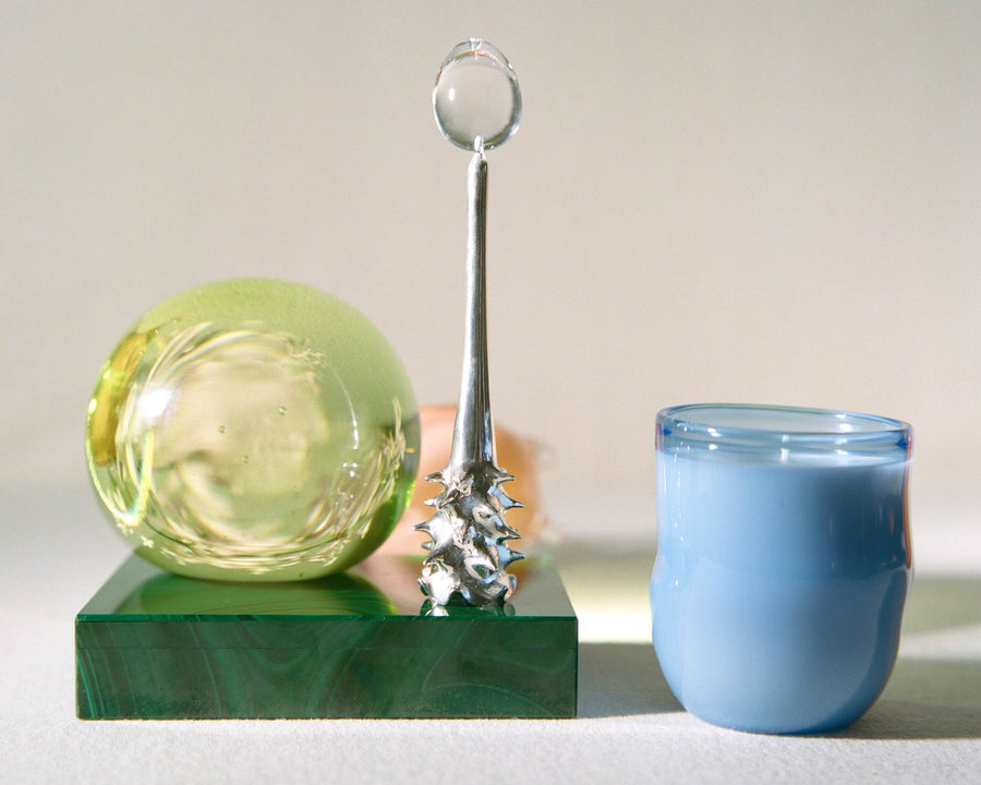Silver Oracle snuffer arranged with a glass sphere and blue candle