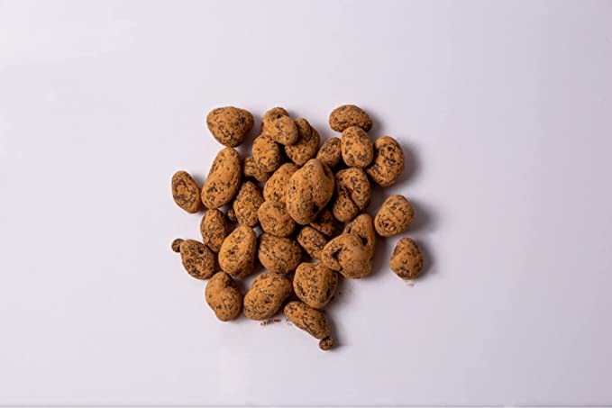 Chocolate-covered raisins arranged on a plain background