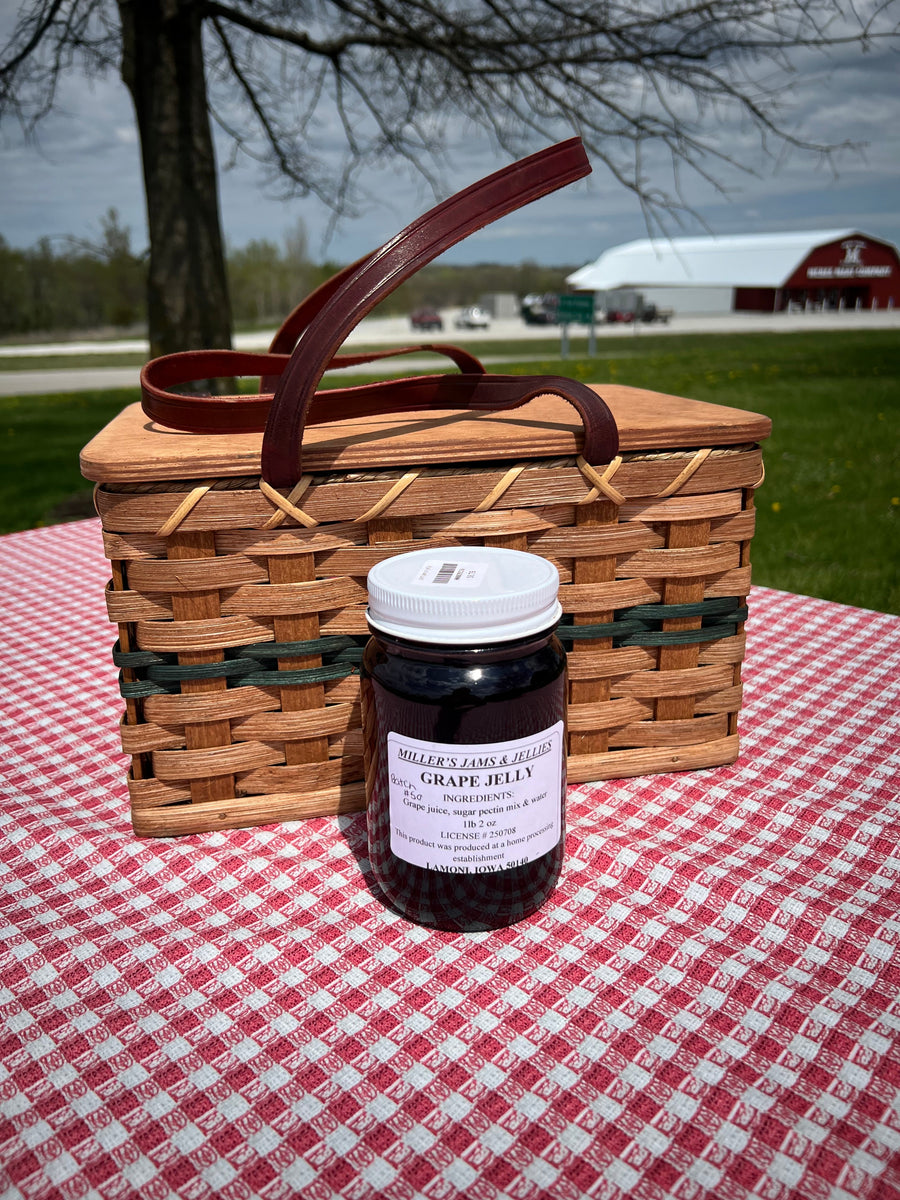 Miller’s Grape Jelly photographed beside a picnic basket outdoors