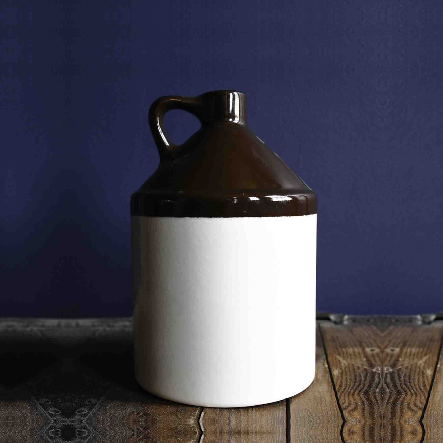 Stoneware Beverage Jug - Half Gallon with a dark shoulder and light lower body on a wood surface