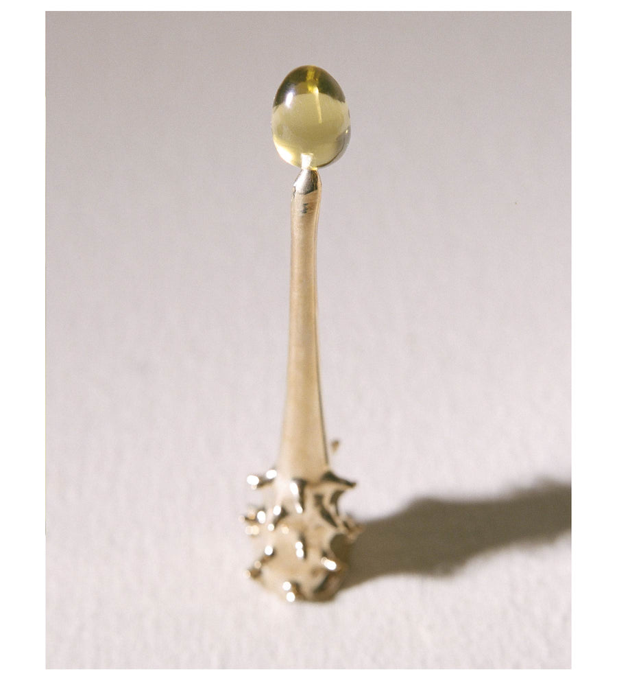 Brass Oracle snuffer standing in warm side light