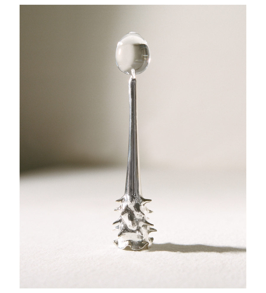 Silver Oracle snuffer standing in warm side light