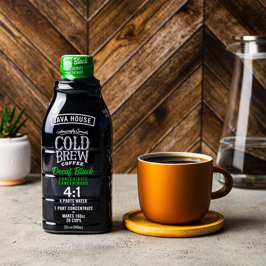 Decaf concentrate beside a hot coffee mug