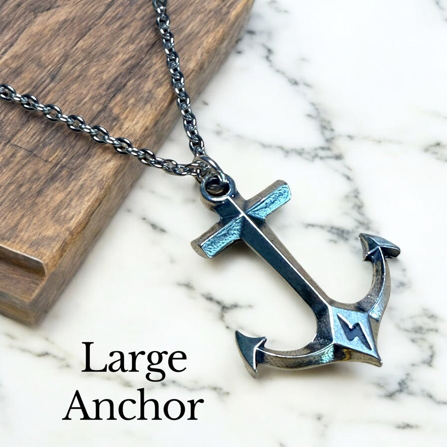 Large anchor pendant against pale stone and wood