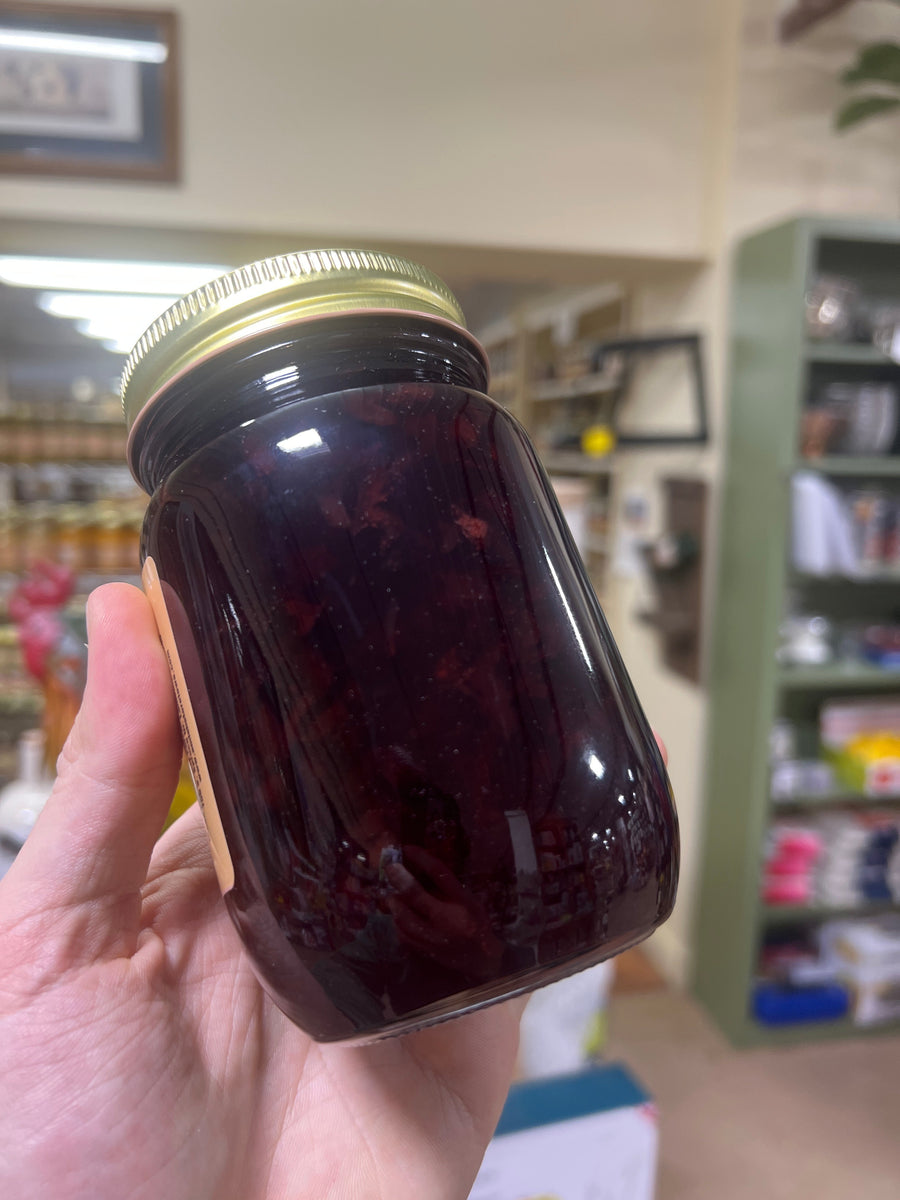 Black Cherry Jam package and ingredient label held in a hand