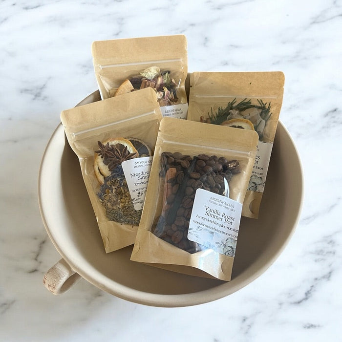 Several pouches of simmer pot botanicals in a shallow bowl