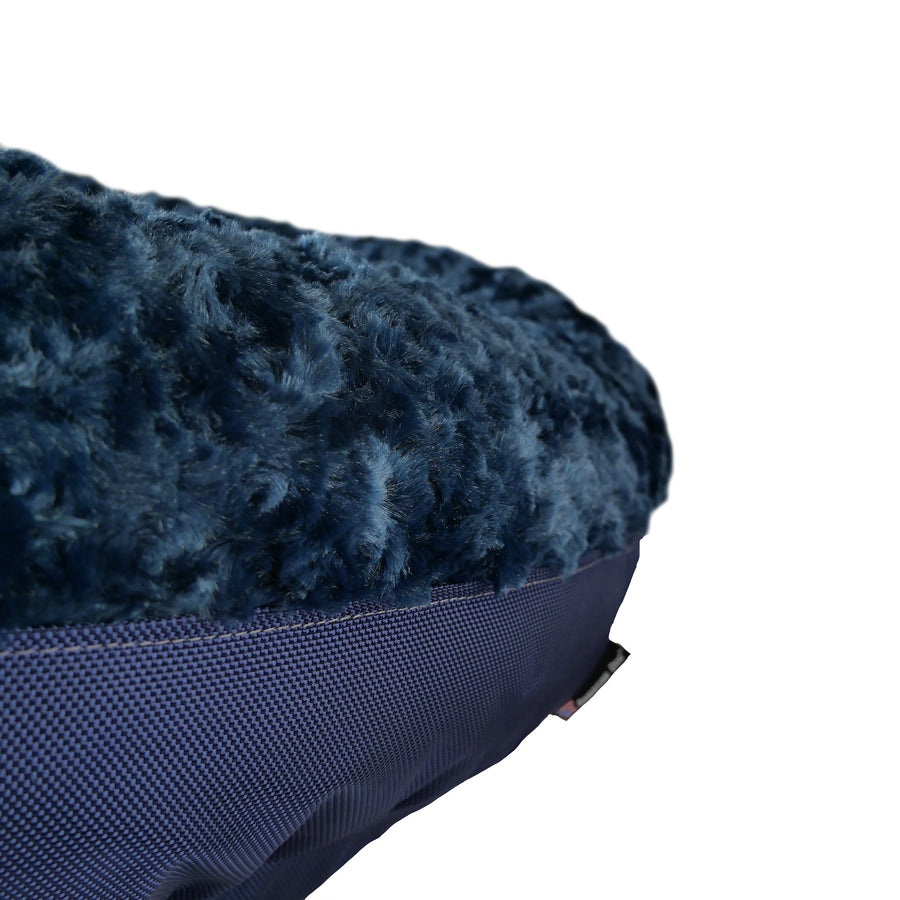 Close-up of midnight blue fleece and side panel on a Furvana round dog bed