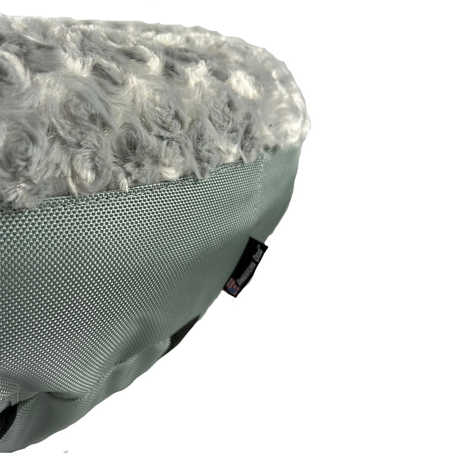 Close-up of silver fleece and side panel on a Furvana round dog bed