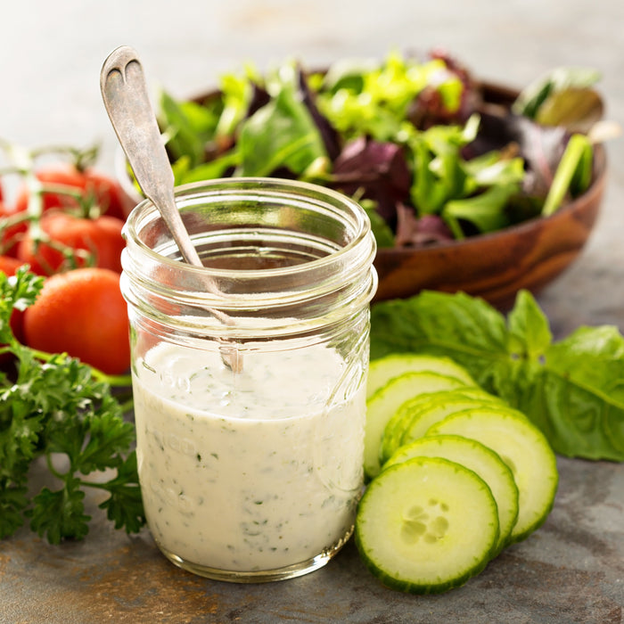 Ranch dressing with a green salad and fresh garlic