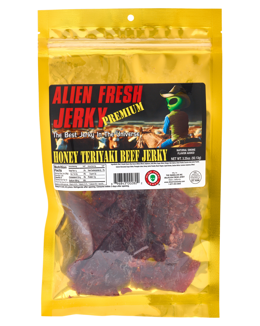 Alien Fresh Jerky Honey Teriyaki beef jerky in a yellow 3.25 oz resealable bag with an alien cowboy label