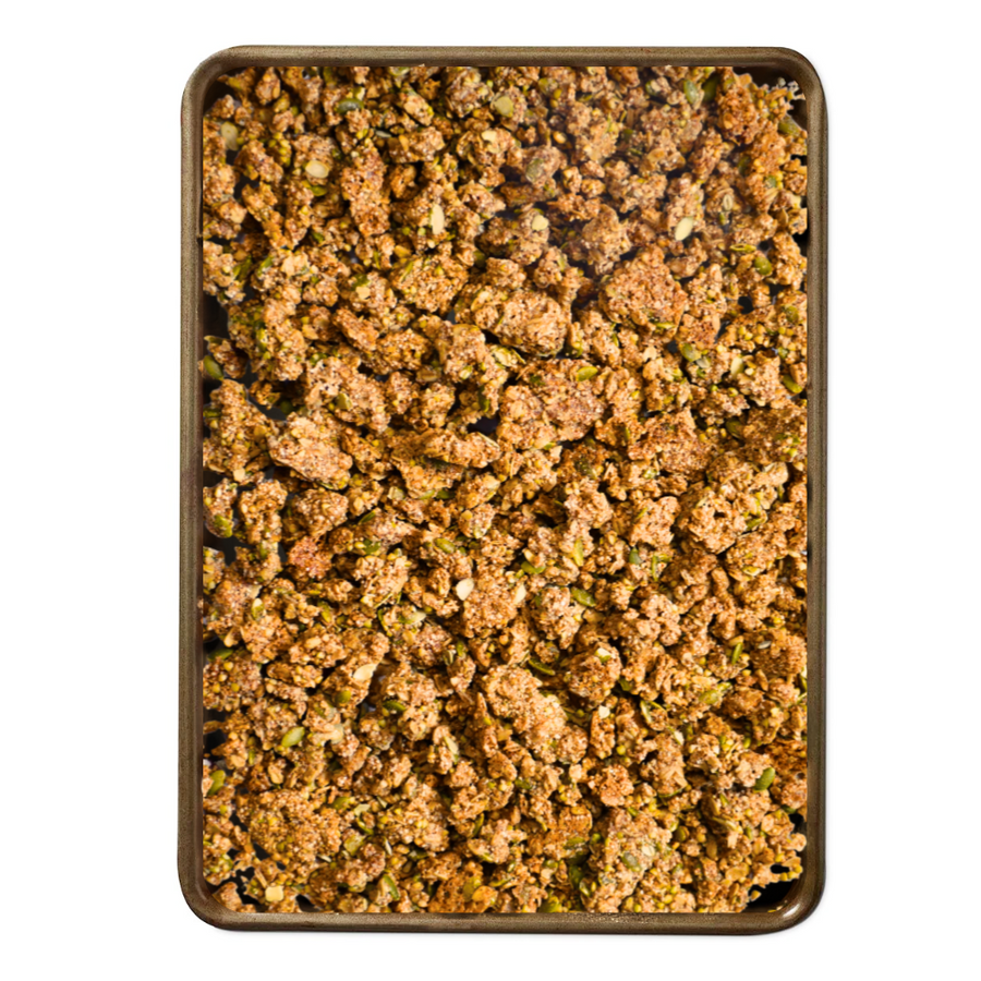Ancient Grain Granola - grain and seed granola spread across a baking tray