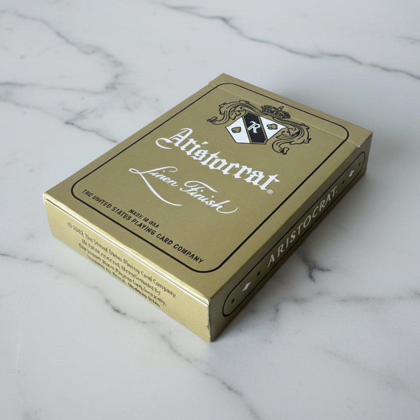 Angled Gold Aristocrat tuck on a wooden surface