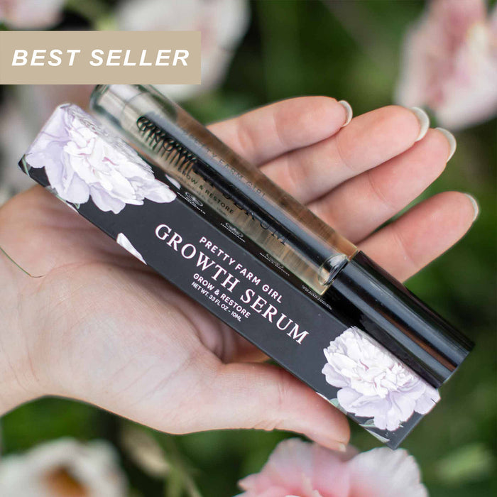 Hand holding lash and brow serum with floral box