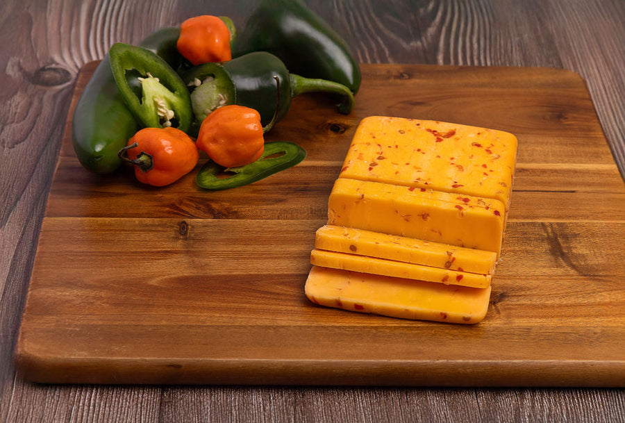 Buffalo Cheddar slices beside peppers
