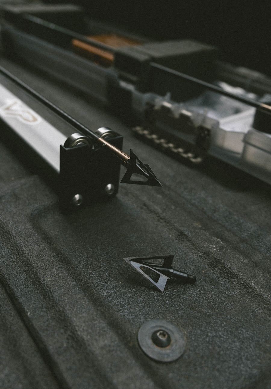 Three-blade broadheads on a machining workbench