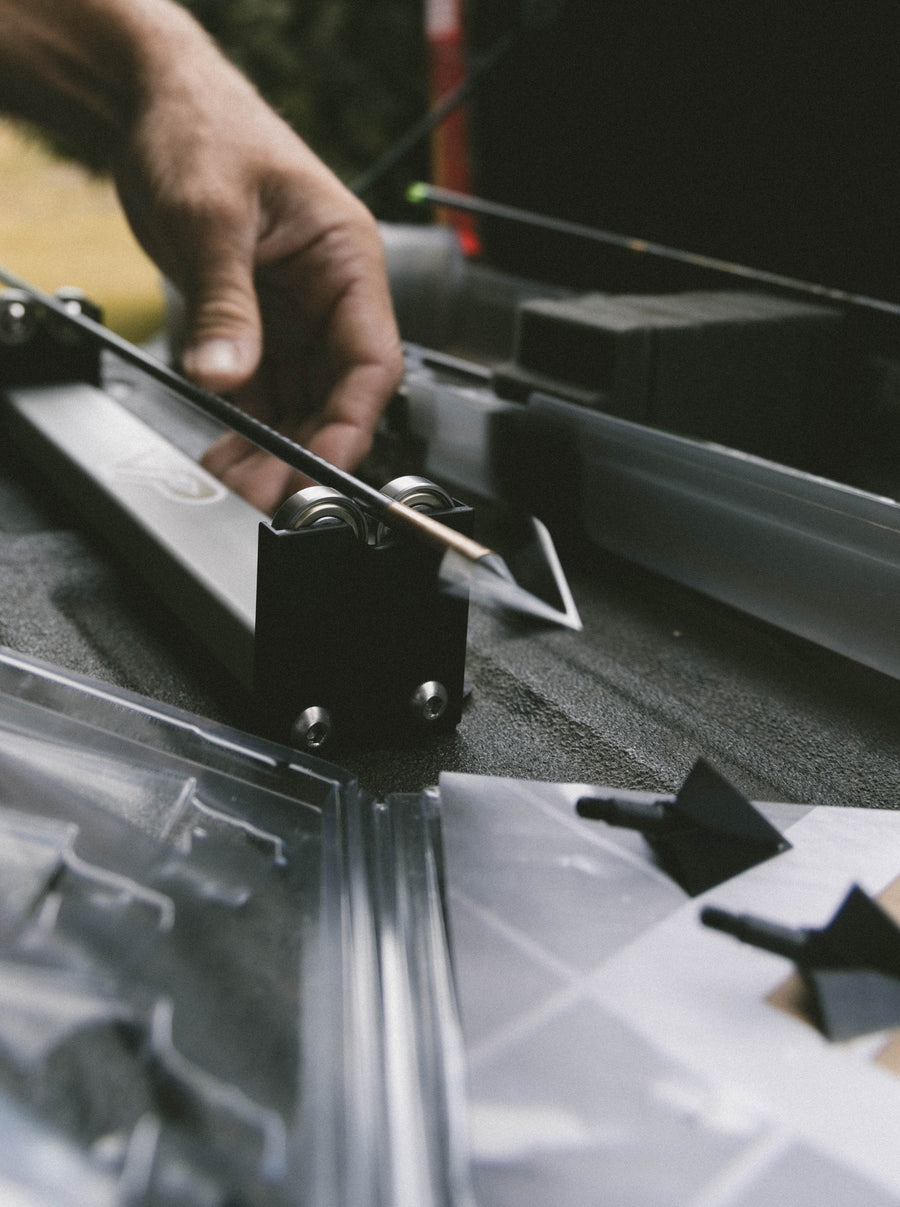 Close view of the spinner rollers supporting an arrow